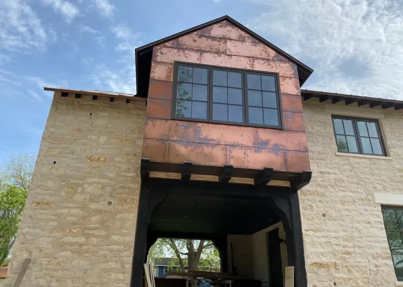Copper metal panel facade on a stone building for Skylight Installation in Hiram